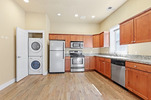 a kitchen with wood cabinets and stainless steel appliances